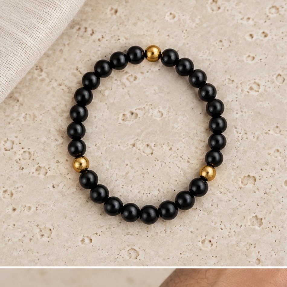Black & Gold-tone Bead Bracelet on travertine