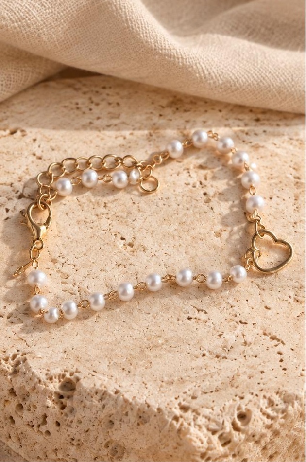 Pearl-like Heart Chain Bracelet on travertine