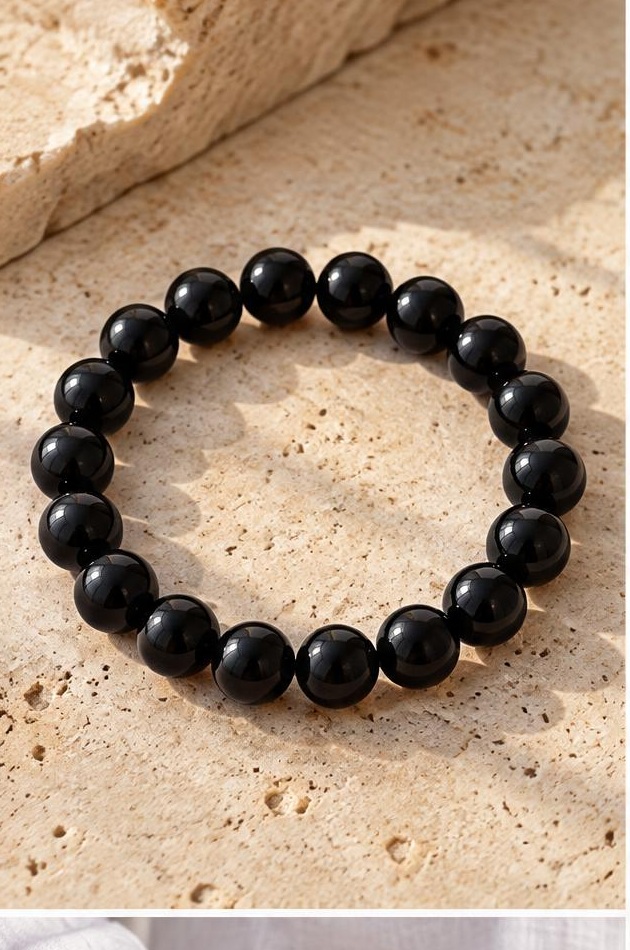 Black Bead Bracelet on travertine