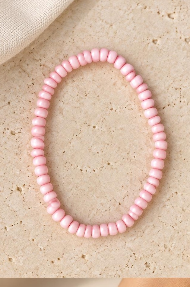 Pink Irregular Bead Bracelet on travertine