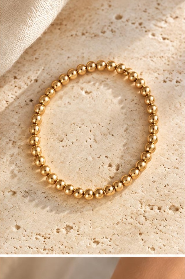 Golden Bead Bracelet on travertine