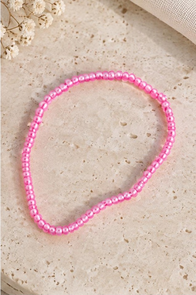 Fuchsia Seed Bead Bracelet on travertine