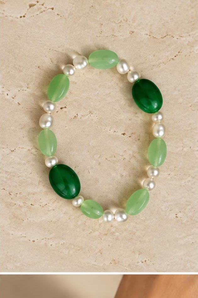 Green & White Bead Bracelet on travertine