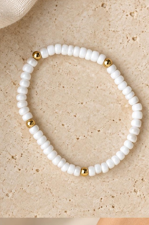 White & Gold-tone Accent Bracelet on travertine