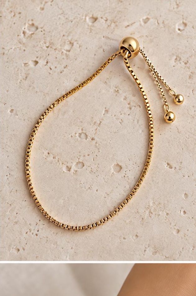 Gold-tone Slider Bracelet on travertine