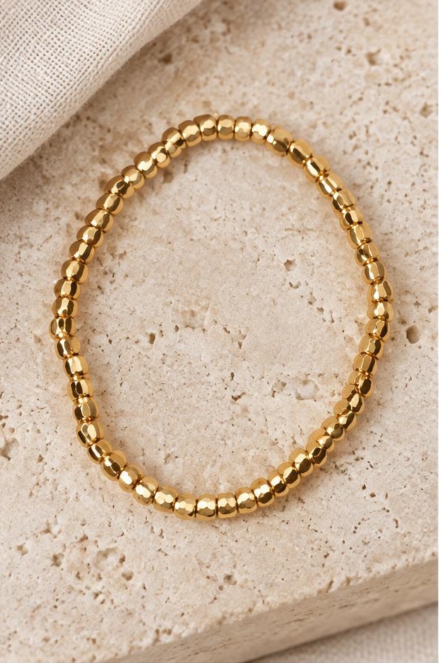 Fine Golden Bead Bracelet on travertine
