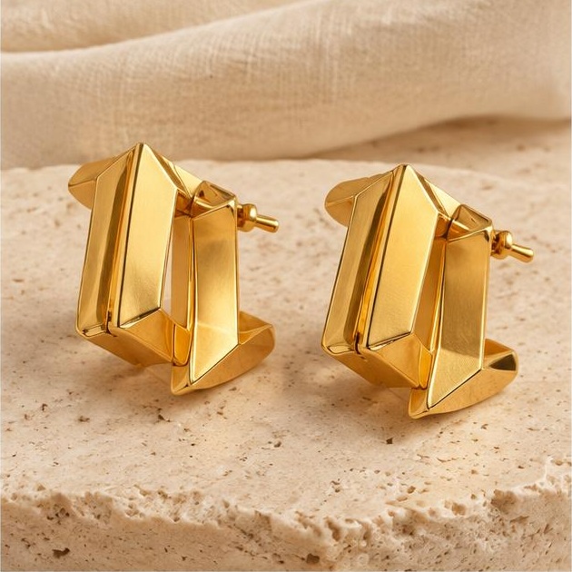 Folded Gold-tone Hoops on travertine