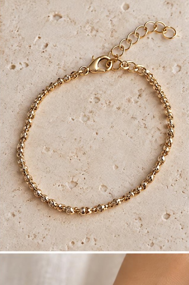 Fine Gold-tone Chain Bracelet on travertine